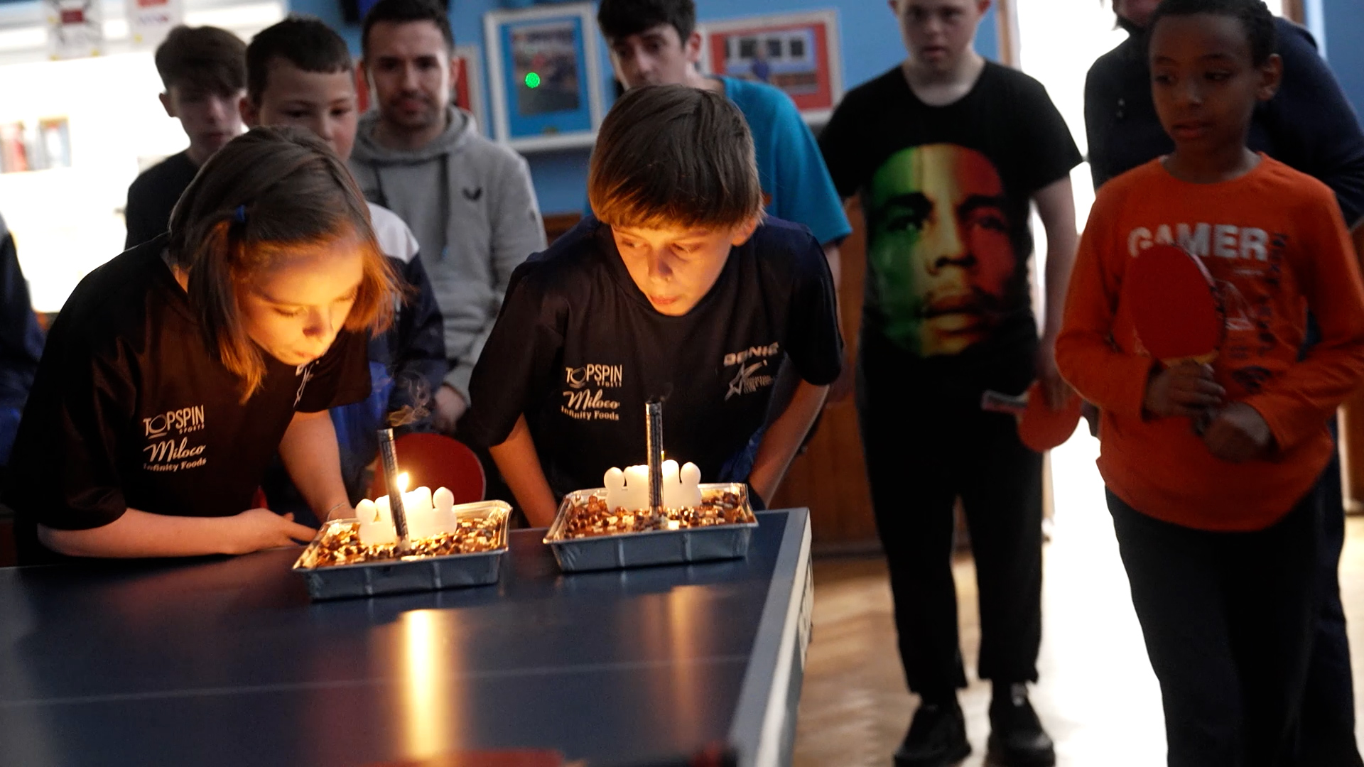 Brighton Table Tennis Club - 2 people celebrating their birthdays, blowing out candles on 2 cakes.