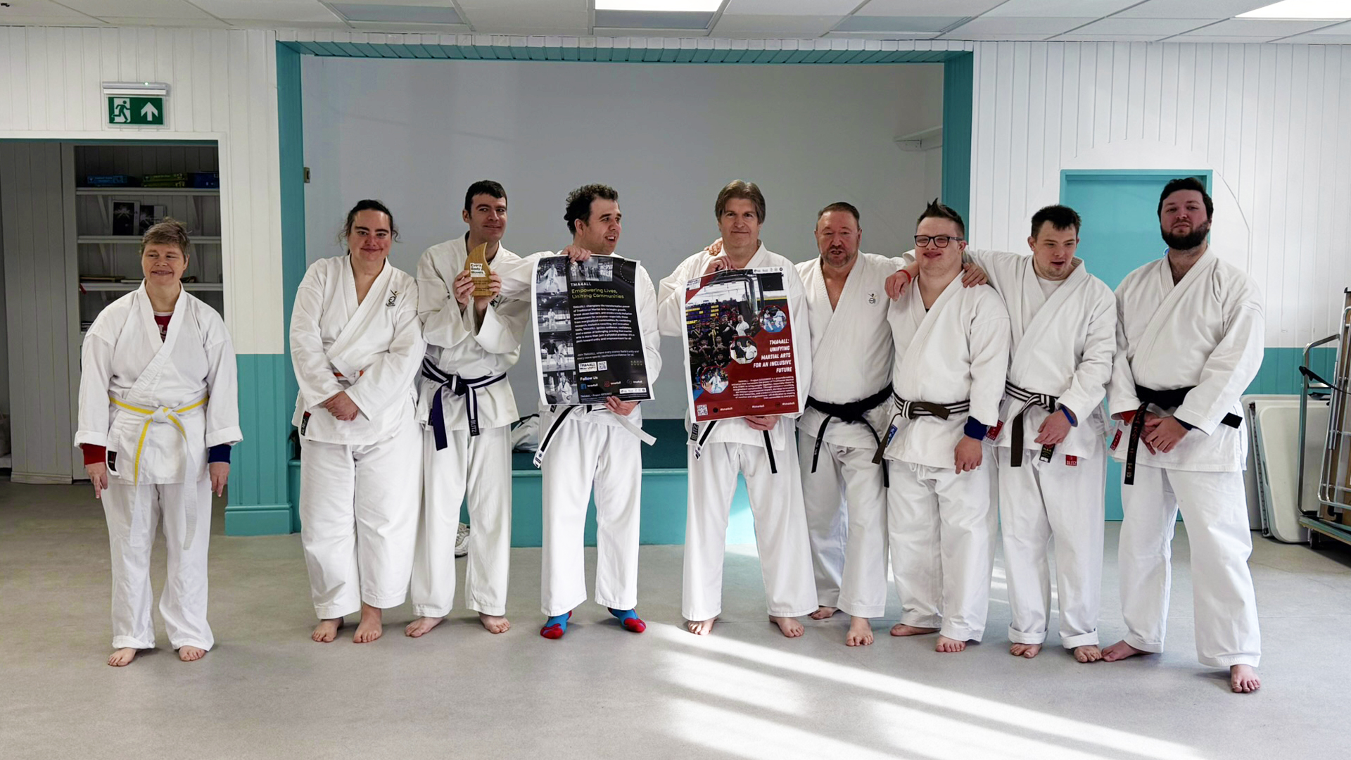 Inclusive karate class, with participant all dressed in their fighting Gis and stood in a row together.