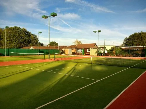 A picture of a tennis court with the sun shining at Enderby Tennis Club