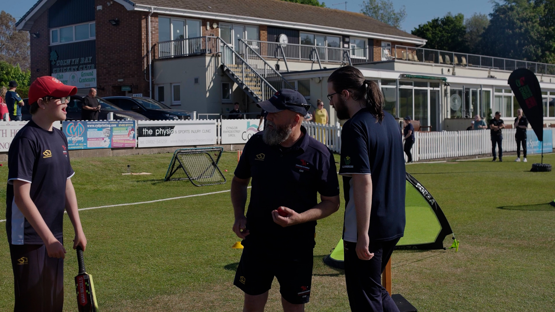 adaptive cricket session with players on the side line chatting