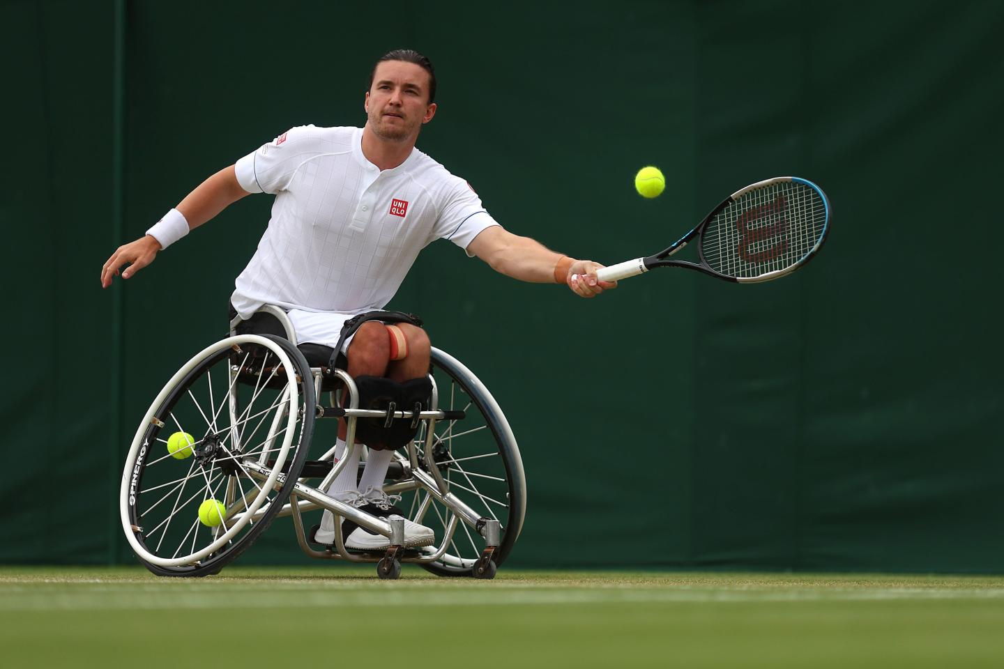 Gordon Reid, wheelchair tennis athlete, mid forehand shot at Wimbledon 2023