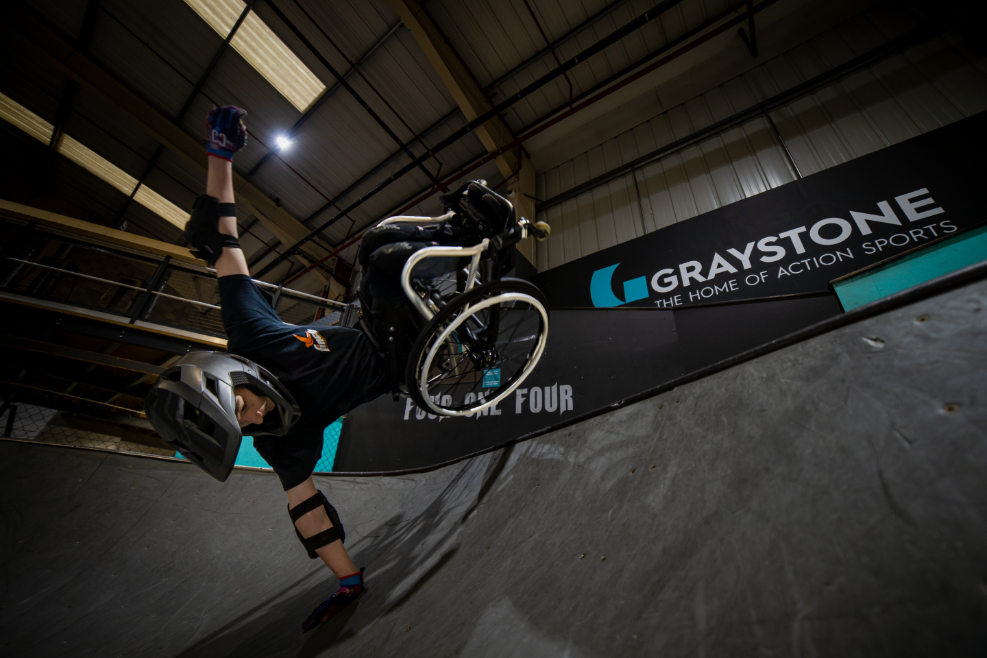 Tomas Woods performs a handplant trick on the side of a steep bank at Graystone Sports Club 