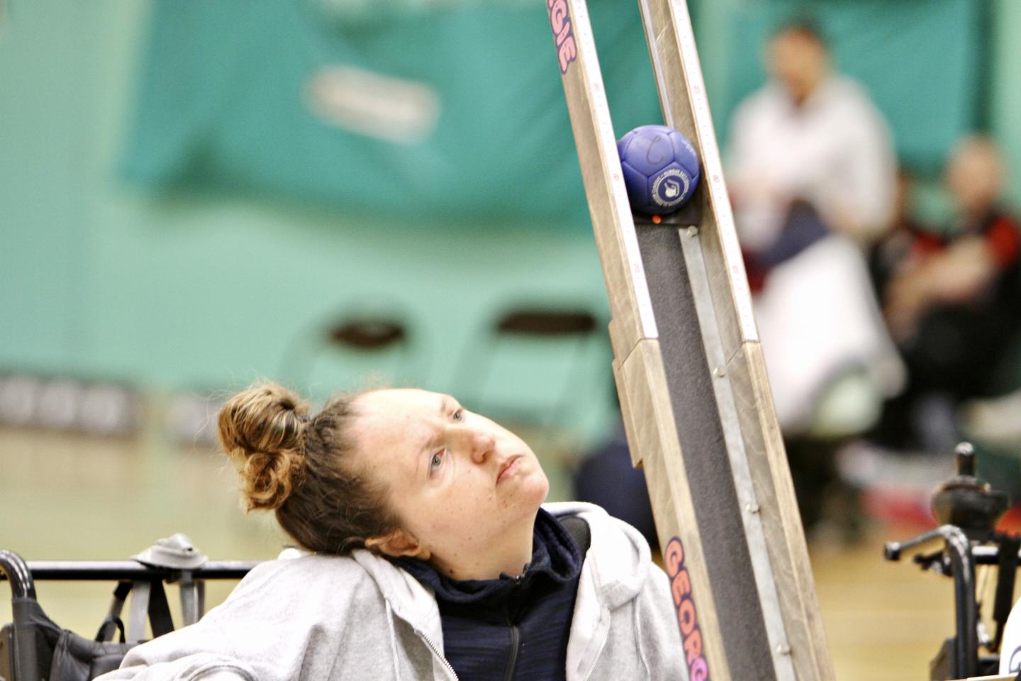 Georgina Moore launches a boccia ball from a ramp