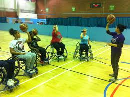Group of people in a practising at wheelchair basketball