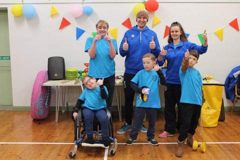 Students from DZ Circus Shool in a group posing with thumbs up.