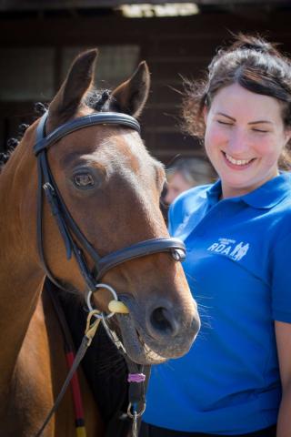 Close-up of young female RDA employee with horse