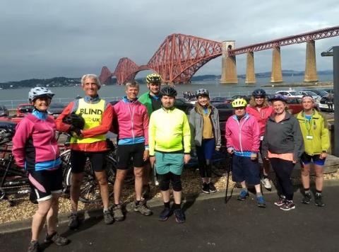 Club riders in front of the Forth Rail Bridge