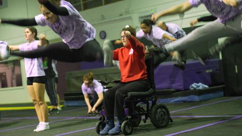 Wheelchair user involved in an adaptive cheerleading routine