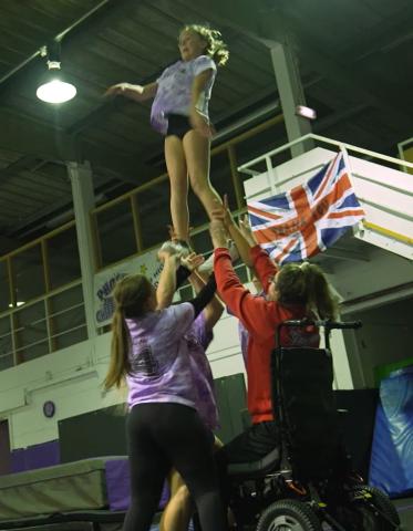 Phoenix allstars adaptive cheer team, with wheelchair user involved in a lift