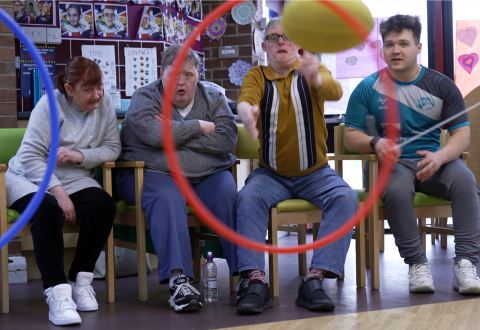 Particpants at the Aspire x Leeds Rhinos Foundation session, throwing foam rugby balls through hoops.