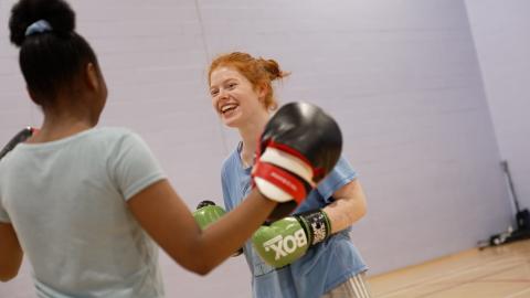 female adaptive boxing participants, practising with gloves and pads