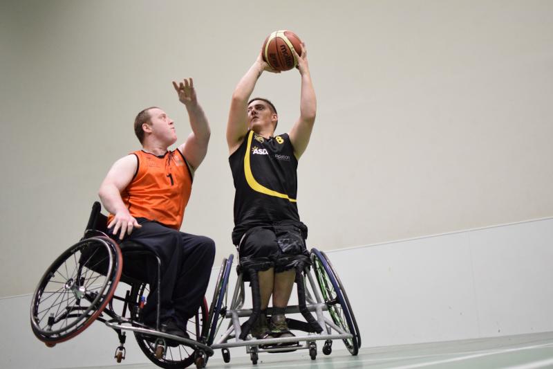 Two wheelchair basketball players