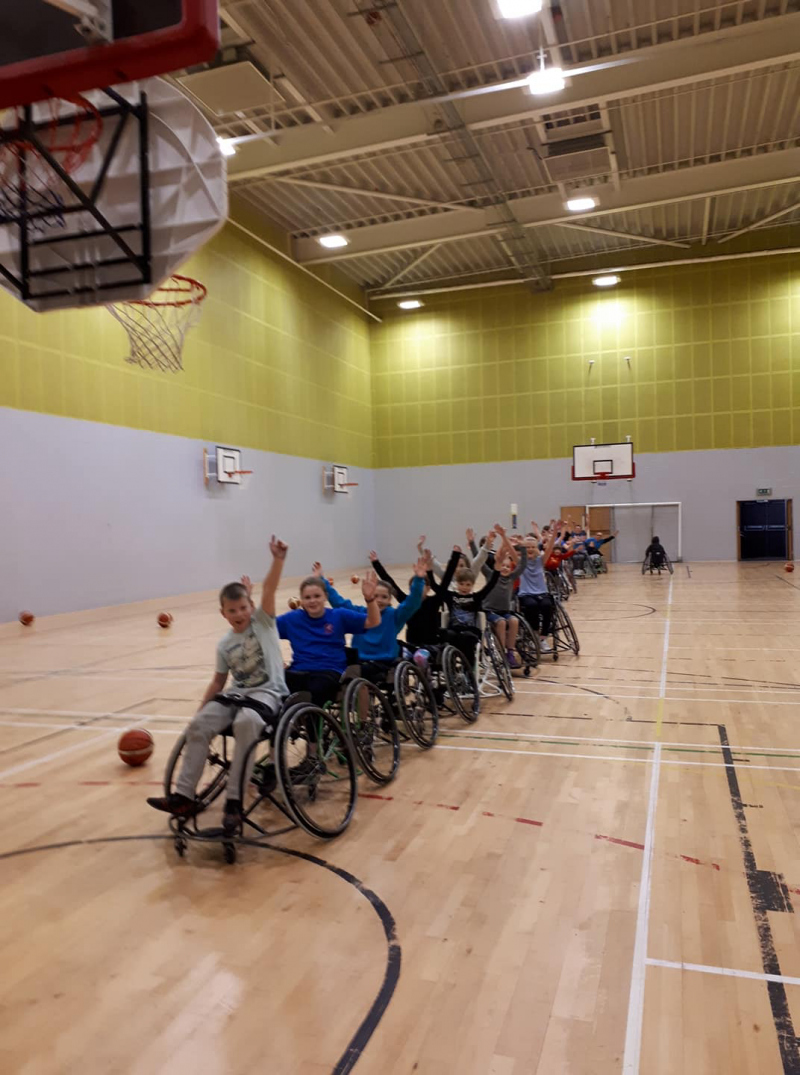 People having fun playing wheelchair basketball
