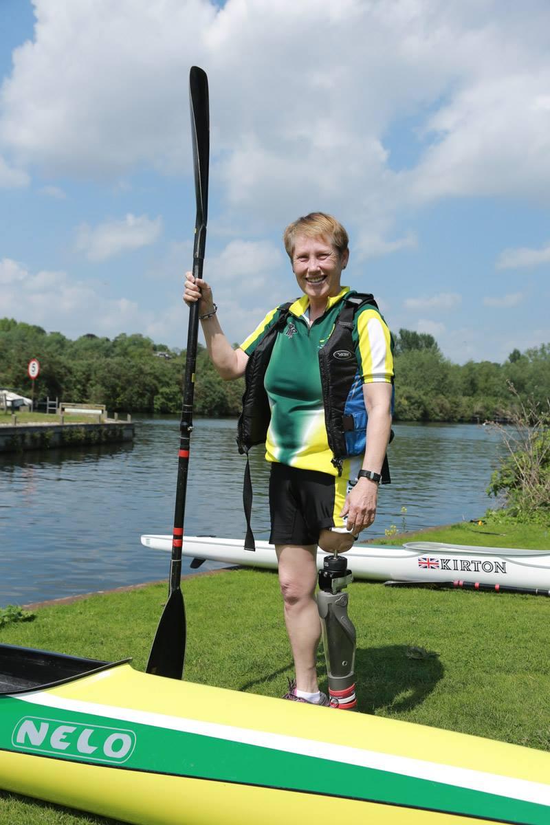 A picture of a amputee Norwich Canoe Club Member standing by a paddle ability kayak