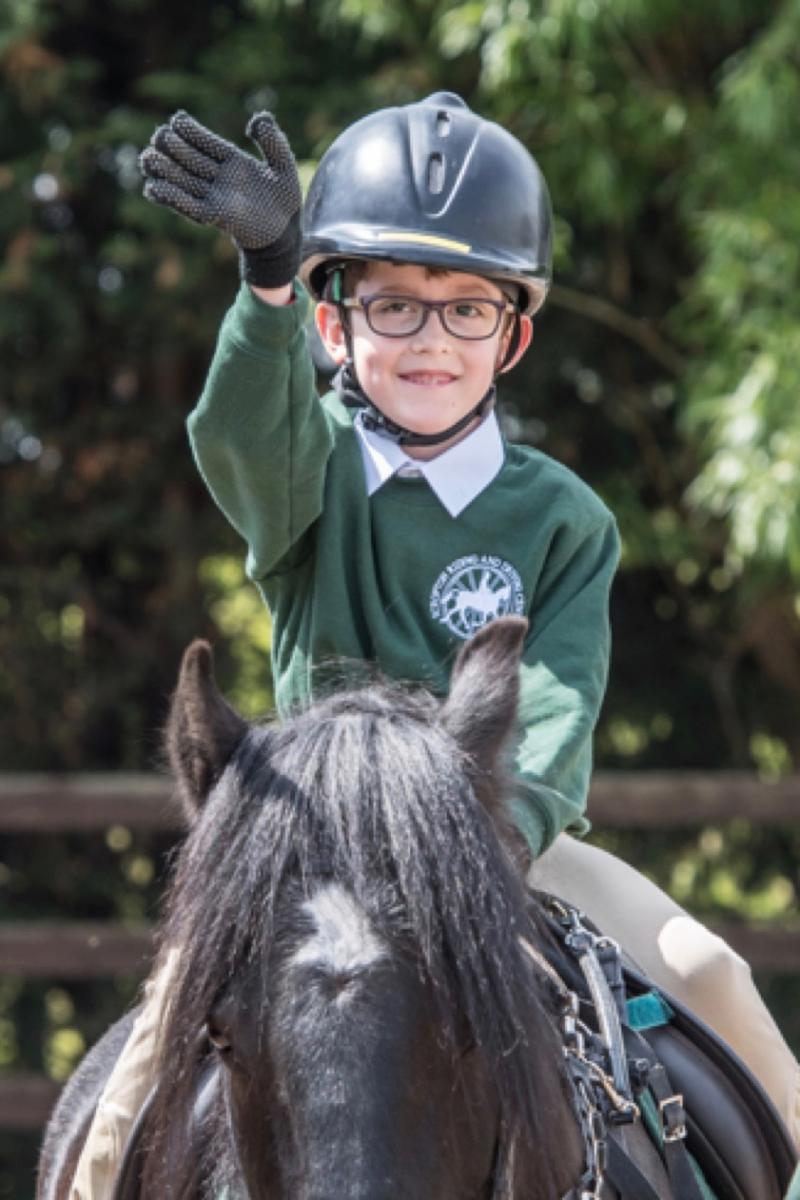 Young boy sitting on pony