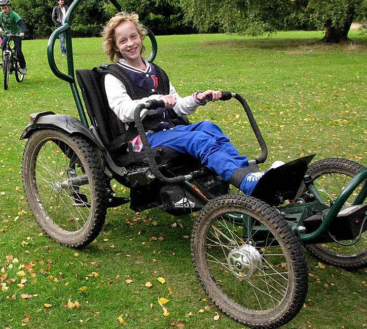 young girl sitting in the Boma (mobility chair bike)