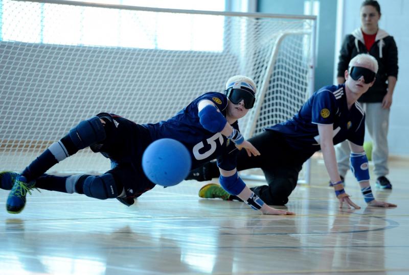 two players diving to save the ball from entering their goal