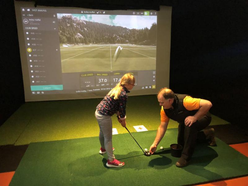 young girl having a golf lesson with PGA pro at a 'Sticks & Stones' Hub event