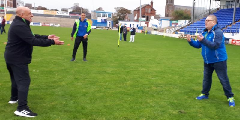 Picture of two Able Raiders taking part in rugby training, overlooked by Advantage! staff member who is also a professional rugby player