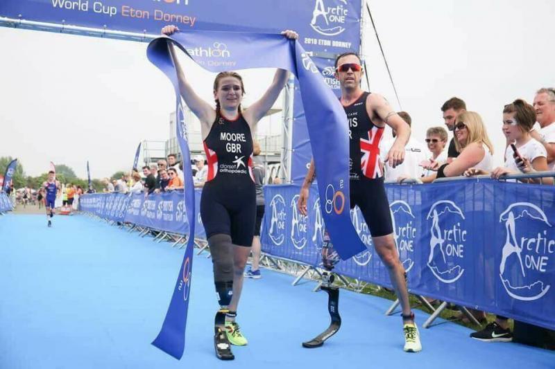 paralympic Champion Andy Lewis cheering on Hannah Moore at the finish line 