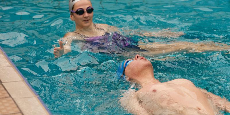 Volunteer and swimmer at WeSwim swimming session