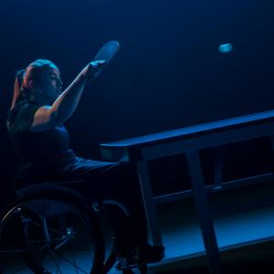 female wheelchair user plays a shot at table tennis