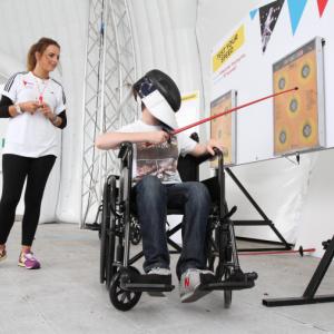 A young person tries wheelchair fencing using a skill game