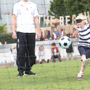 Blindfolded boy takes a shot at blind football