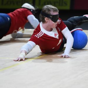 People playing goalball while wearing a blindfold