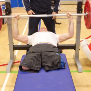 Bench pressing in a gym