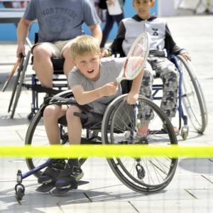 boy plays wheelchair tennis