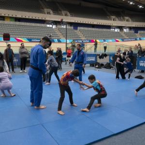 A group of Paralympic potentials try out Judo on a blue mat.