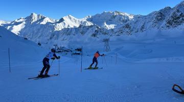 Sam Cozens following his guide Adam Hall who is wearing an orange bib