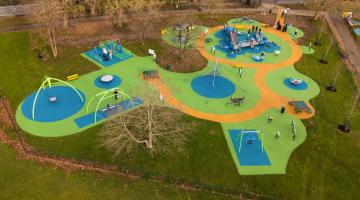 A birds eye view of an inclusive playground, with a multitude of accessible equipment