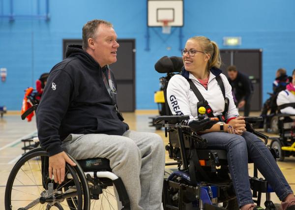 Hannah Cockroft talks to powerchair football coach