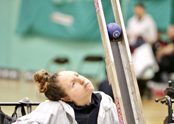 Georgina Moore launches a boccia ball from a ramp