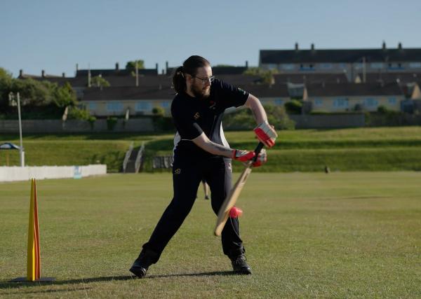 inclusive cricketer mid batting shot.